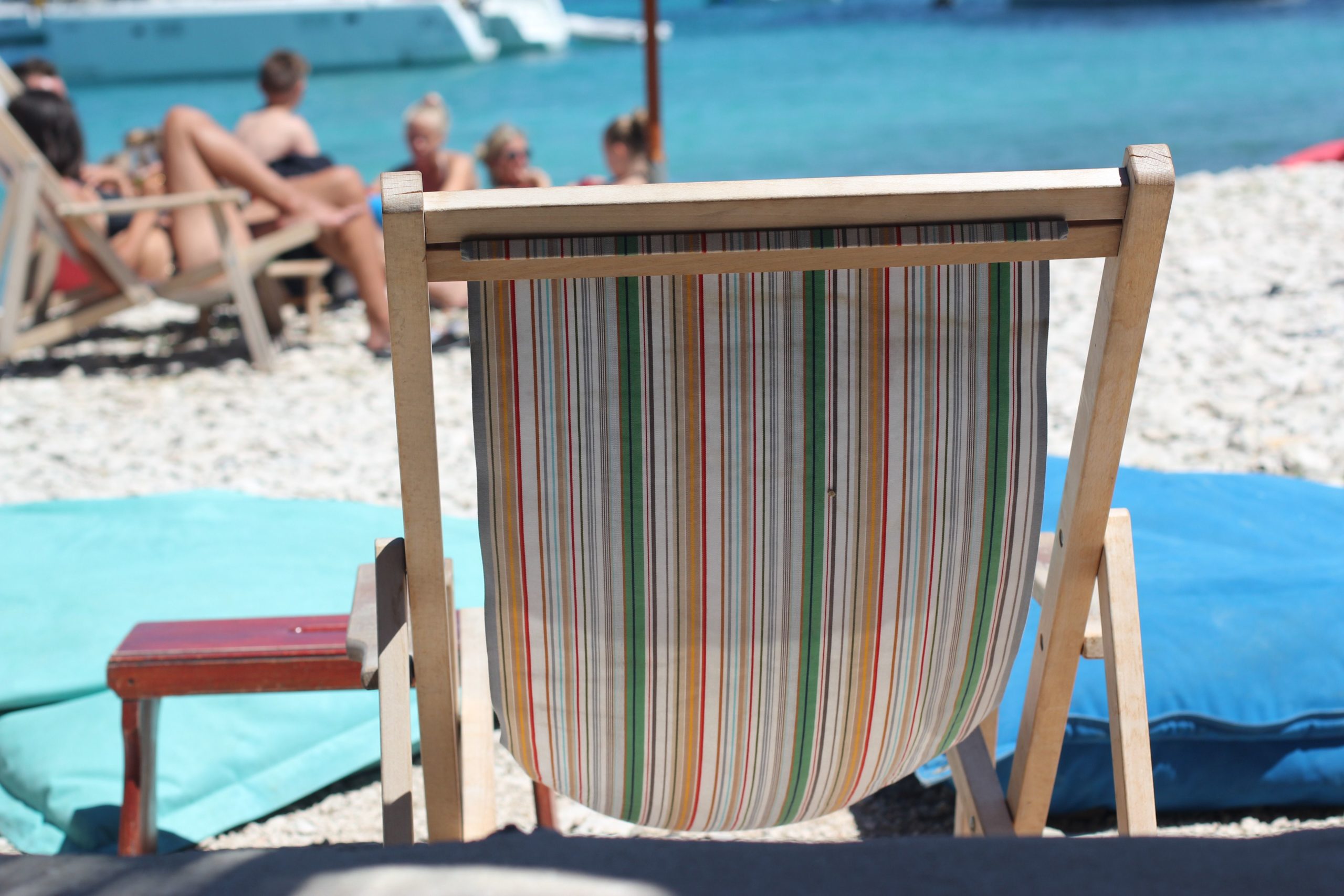 The best time to visit Croatia, summer deck chair and people resting on the beach
