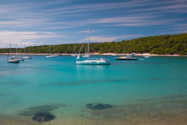 Boats in crystal blue water - AndAdventure Croatia